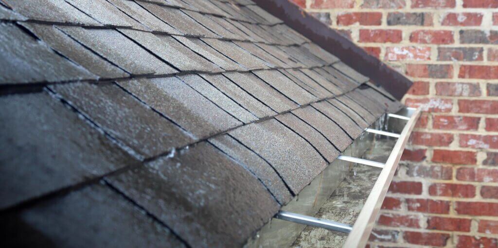 Cracked shingles indicating a roof leak