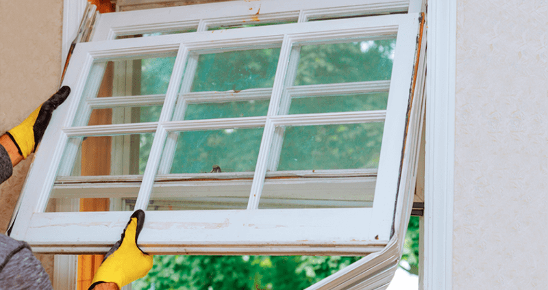 male worker demonstrating a window replacement on an old window