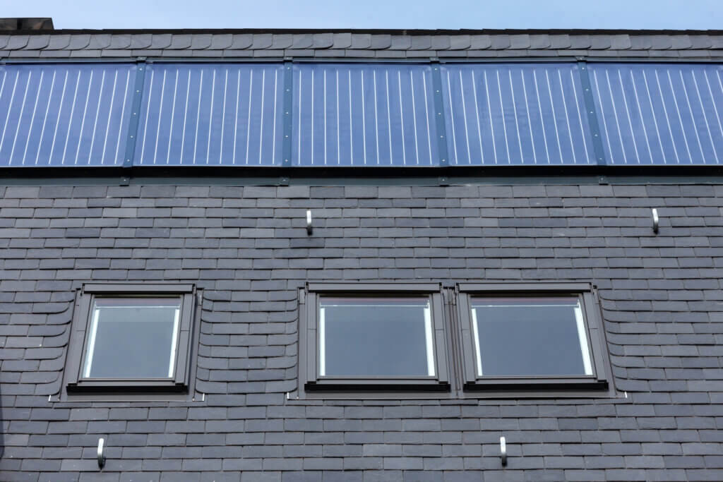 Roof of black slate tiles, roof Windows and fixed solar panels